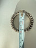 Vintage rhinestone expansion bracelet beside measuring tape for size reference