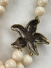 Back of Heidi Daus starfish pendant showing designer and bronze tone metal construction 