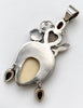 Back of vintage Queen of Hearts goddess pendant showing silver construction and large pendant bail