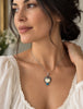 Vintage Balinese carved face silver pendant worn on necklace showing size and scale