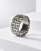 Angled view of signed OPUS Brutalist sterling silver ring showing sculptural pattern