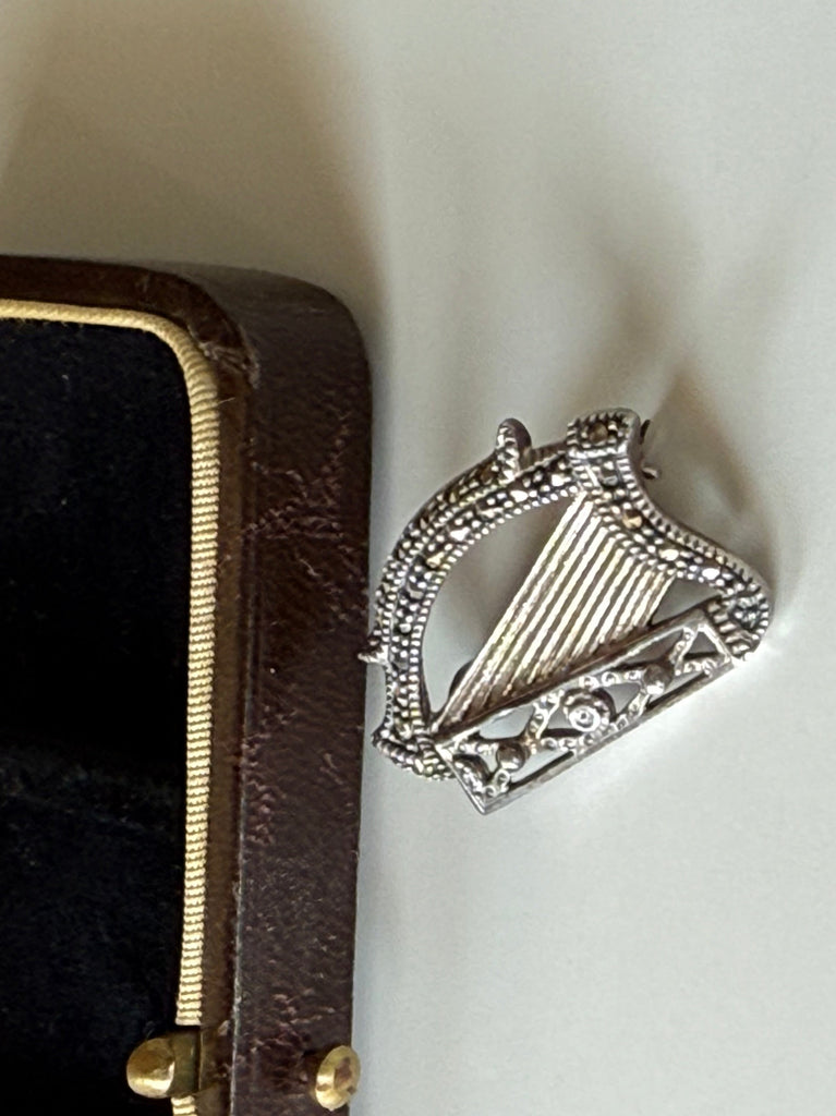 Irish harp marcasite brooch displayed beside open jewellery box