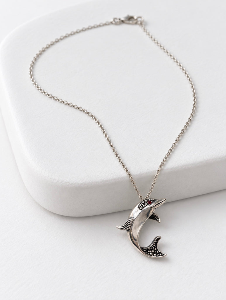 Vintage Ecco 925 sterling silver dolphin pendant necklace displayed on white jewellery stand