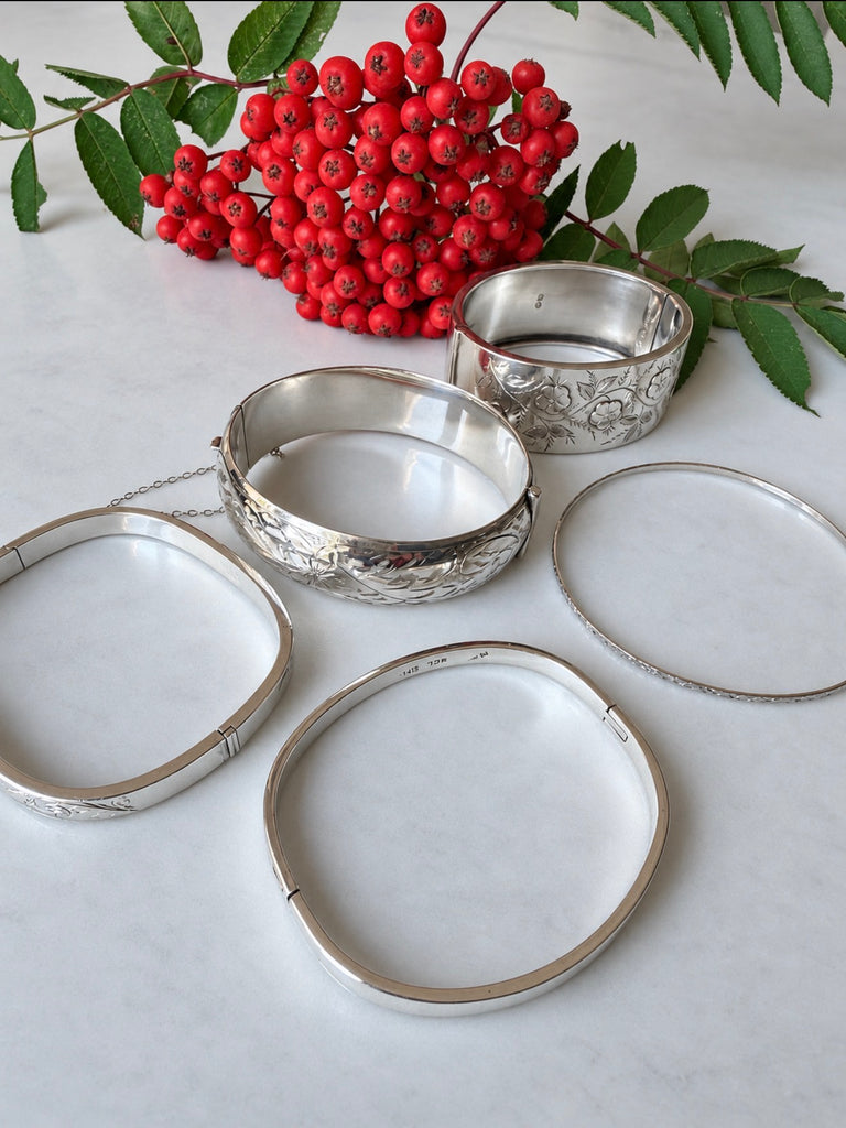 Sterling silver hammered bangle bracelet displayed with silver jewellery