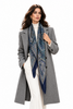 Woman wearing oversized blue Italian paisley scarf draped around neck