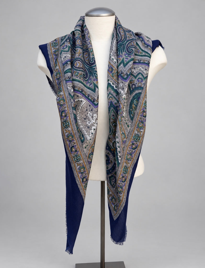 Vintage blue and teal paisley shawl displayed over white mannequin