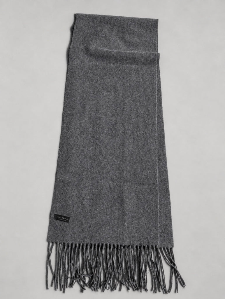 Charcoal grey cashmere scarf laid flat showing rectangular shape and fringed ends