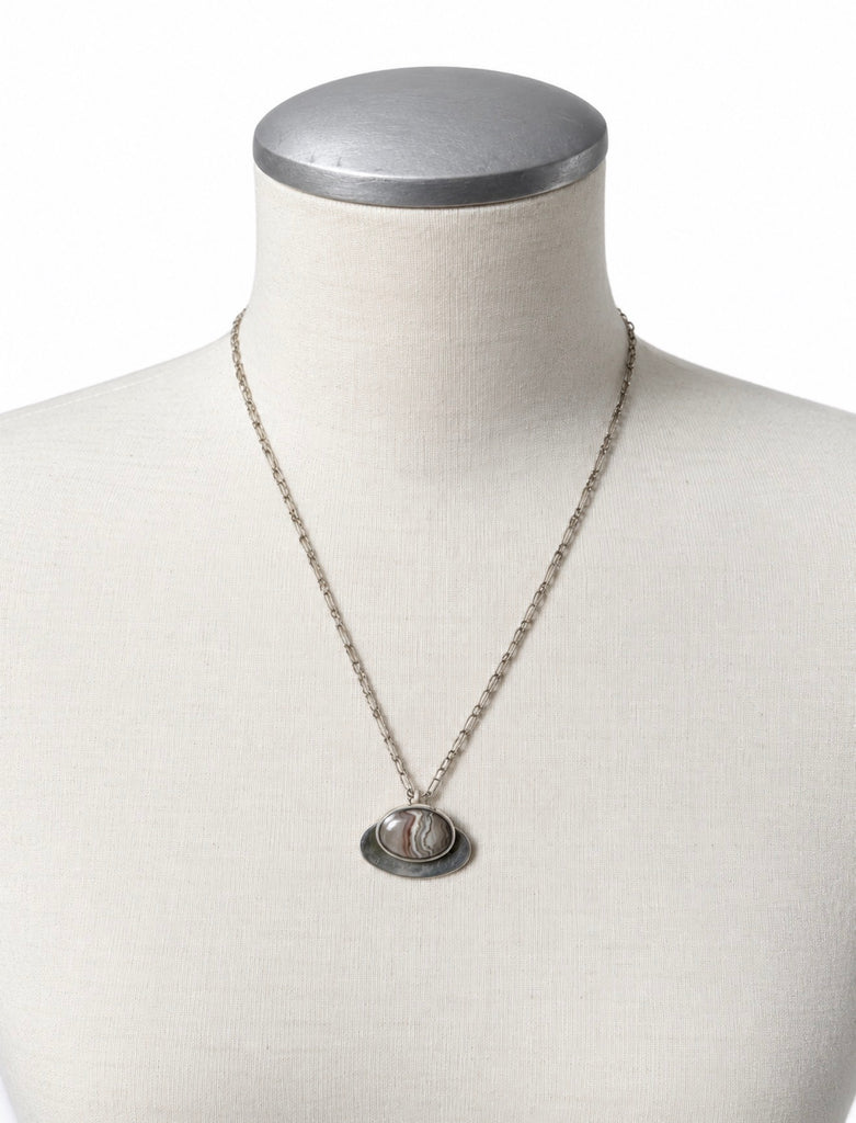 Vintage banded agate pendant necklace displayed on jewellery bust