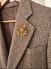 Vintage Sarah Coventry flower brooch worn on blazer lapel