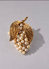 Vintage faux pearl grape cluster brooch with gold-tone leaves and clear rhinestones