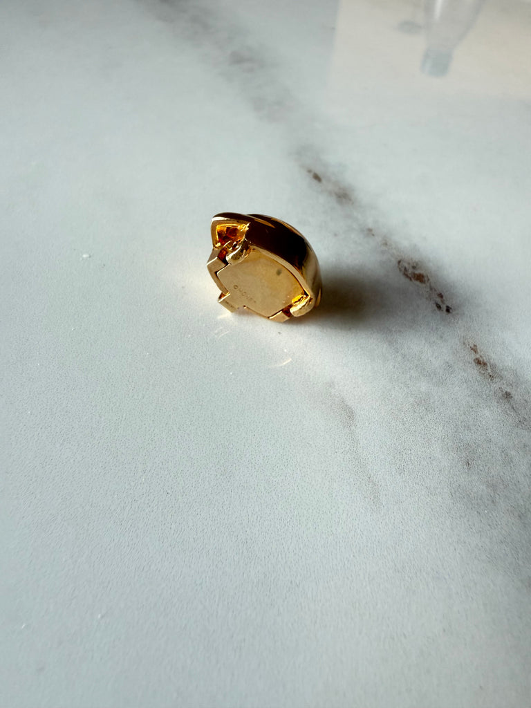 Back of vintage gold-tone jewellery clasp showing fold-over mechanism