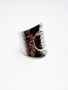Side view of hammered silver ring showing flowing open band design