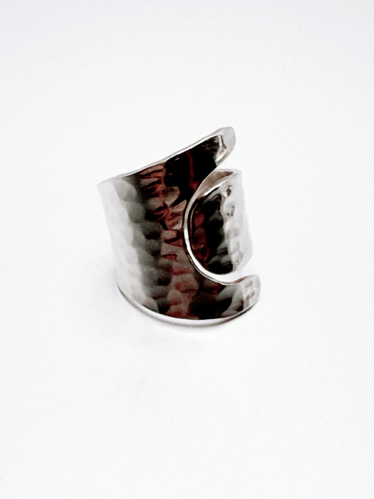 Side view of hammered silver ring showing flowing open band design