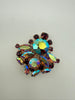 Front view of vintage AB rhinestone cluster brooch with purple round and marquise accent stones