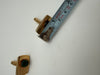 Side view of vintage green stone cufflink shown with measuring tape for scale