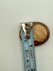 Vintage shell cameo brooch shown with measuring tape at approximately 2.7 cm wide