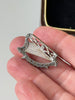 Vintage Solvar Irish harp brooch held in hand showing its size