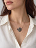 Art Nouveau silver maiden necklace worn with a white blouse