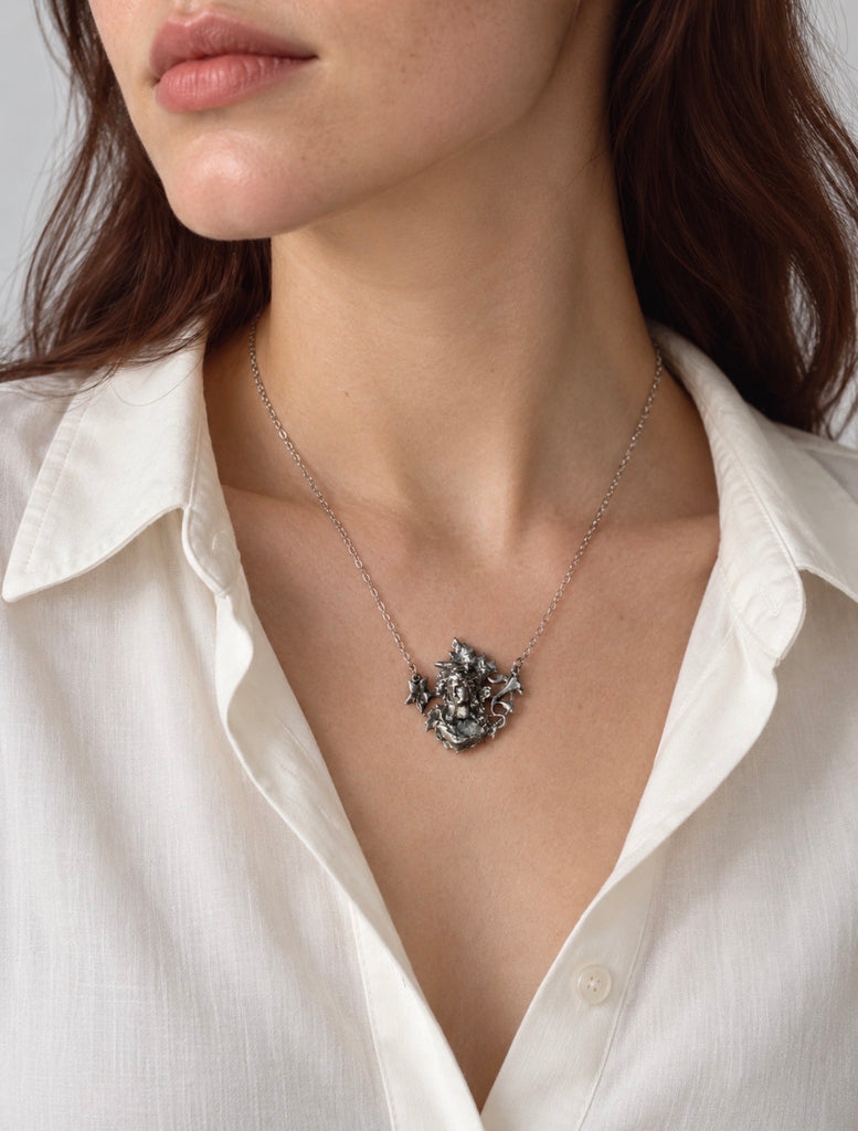 Art Nouveau silver maiden necklace worn with a white blouse
