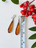1. Vintage honey-brown amber teardrop earrings measuring approximately 2 inches in length