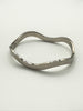 Vintage Mexican sterling silver hinged bangle shown open on white background