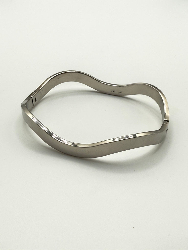 Vintage Mexican sterling silver hinged bangle shown open on white background