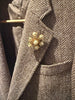 Vintage faux pearl floral starburst brooch worn on grey blazer
