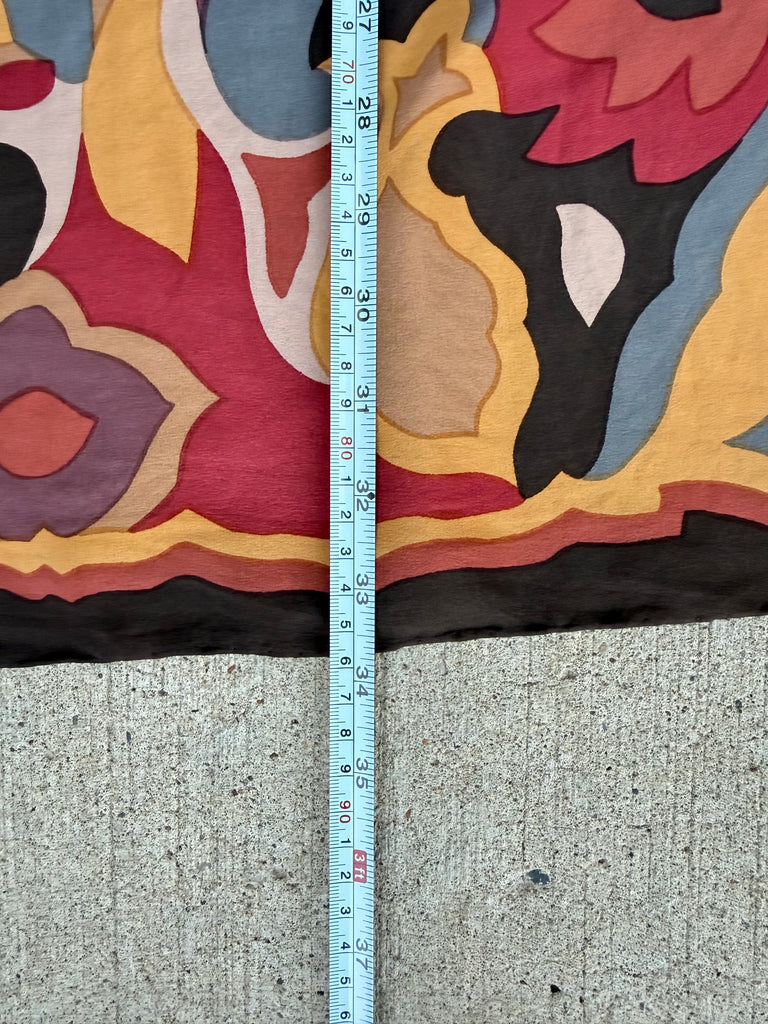 A close-up with a tape measure standing vertically to show the fabric width of 33 inches. 