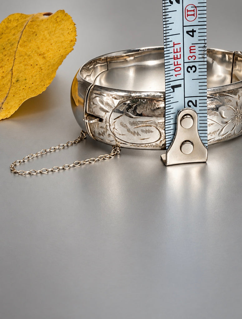 Vintage Ladye Fayre silver bangle beside measuring tape showing bracelet height