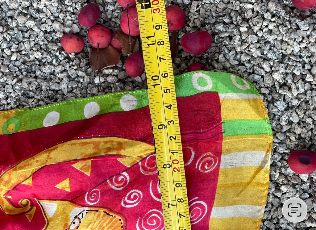 Vintage cat print silk scarf shown with measuring tape across the fabric. 