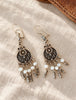 Pair of ornate sterling silver filigree dangle earrings displayed together