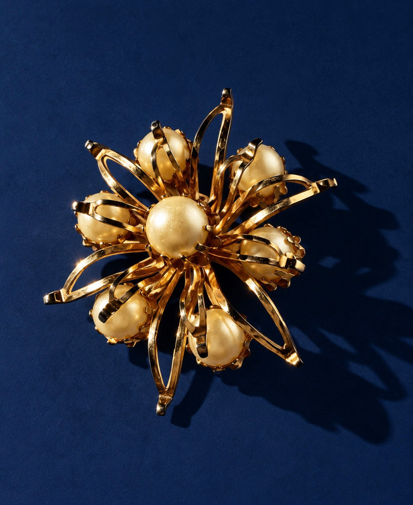 Vintage gold-tone faux pearl flower brooch with sculptural starburst design