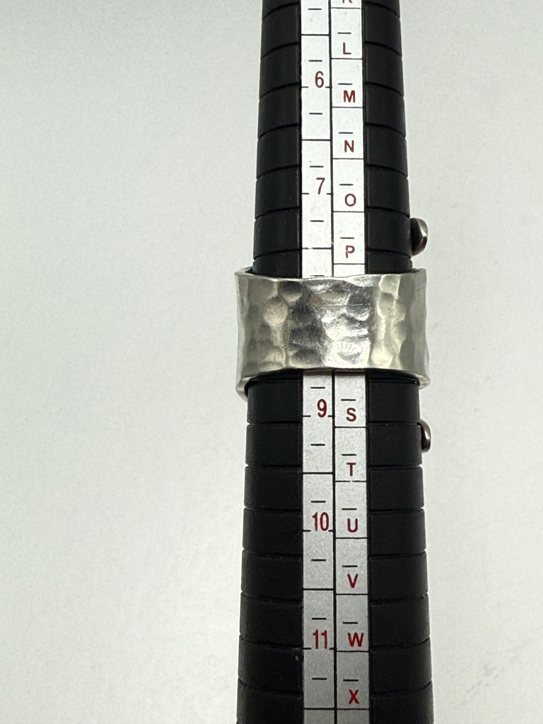 Vintage 925 sterling silver ring photographed beside ring sizing mandrel