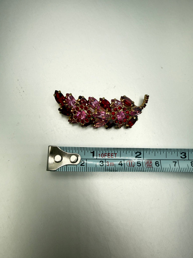 Vintage pink rhinestone branch brooch showing length