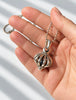 Retired LAGOS Signature Caviar birdcage pendant shown in hand for scale