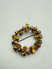 Front view of vintage Austrian crystal wreath brooch with prong-set iridescent stones