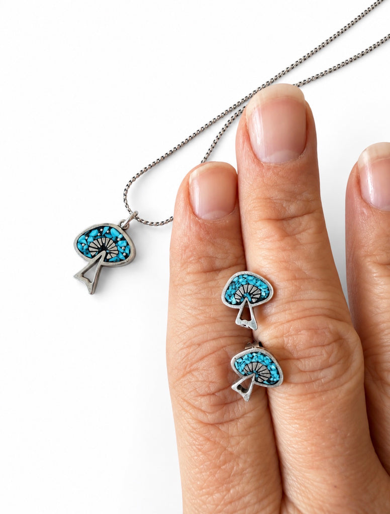 Turquoise mosaic post earrings shown in hand for scale
