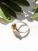 Side view of Baltic amber ring showing sculptural sterling silver setting