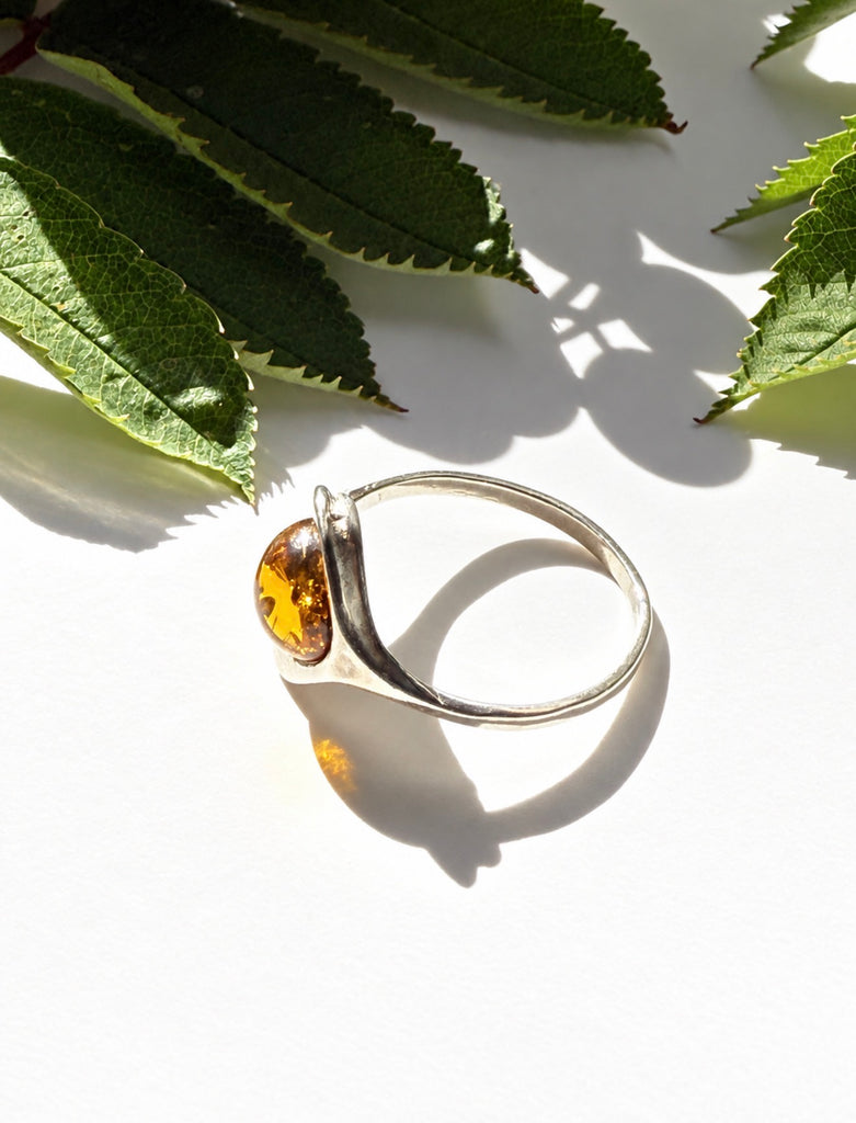 Side view of Baltic amber ring showing sculptural sterling silver setting