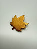 Front view of textured gold-tone Canadian maple leaf brooch dated 1970