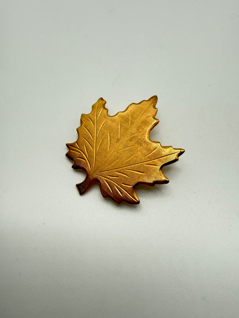 Front view of textured gold-tone Canadian maple leaf brooch dated 1970