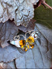 David-Andersen Norwegian enamel butterfly brooch displayed on dark fabric