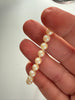 Close-up of genuine freshwater pearls showing warm cream colour and natural variation
