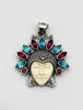 Front of ornate Balinese 925 silver pendant with carved cream face and alternating red and blue gemstones