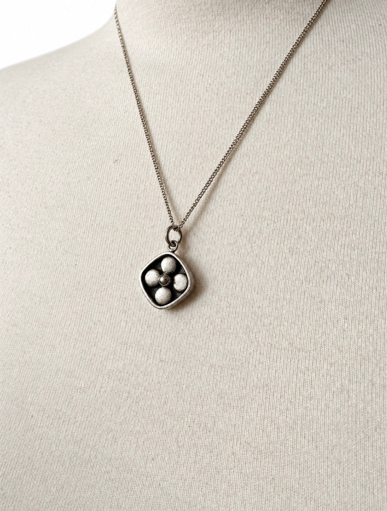 Vintage Kultaseppä Salovaara sculptural pendant necklace displayed on white background