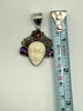Vintage Balinese goddess pendant beside measuring tape showing approximately 1.75 inch length