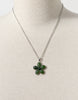 Green jade flower pendant necklace displayed on white jewellery bust