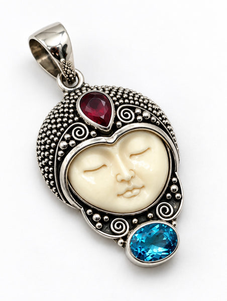 Vintage Balinese 925 silver pendant with carved cream face and red and blue stone accents