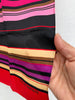 Close-up of Harve Benard silk scarf showing colourful striped print and lightweight silk fabric. 
