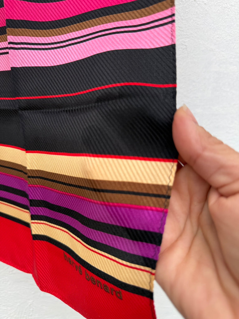 Close-up of Harve Benard silk scarf showing colourful striped print and lightweight silk fabric. 